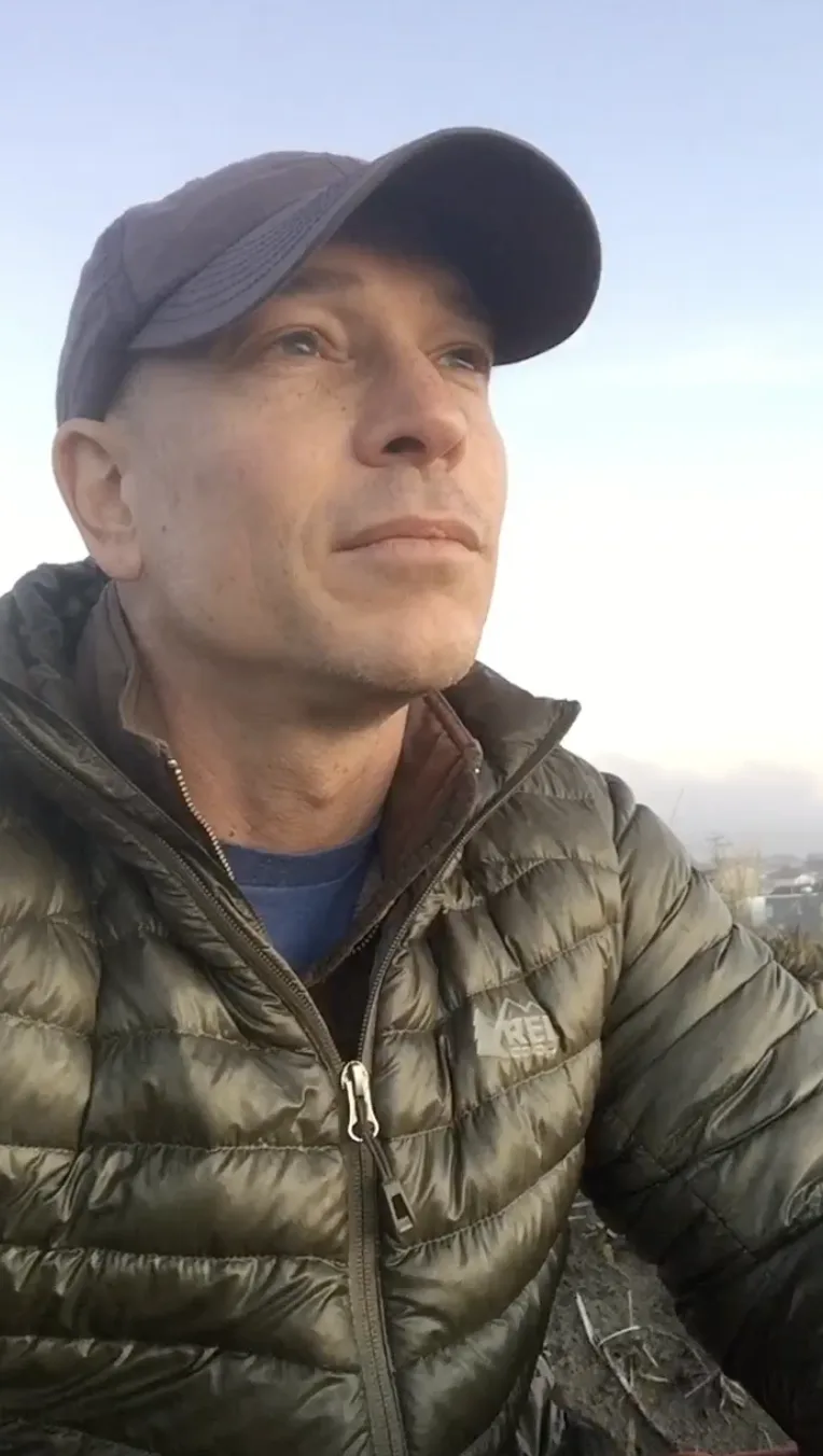 Jonah Larkin outdoors on the coast in the early morning